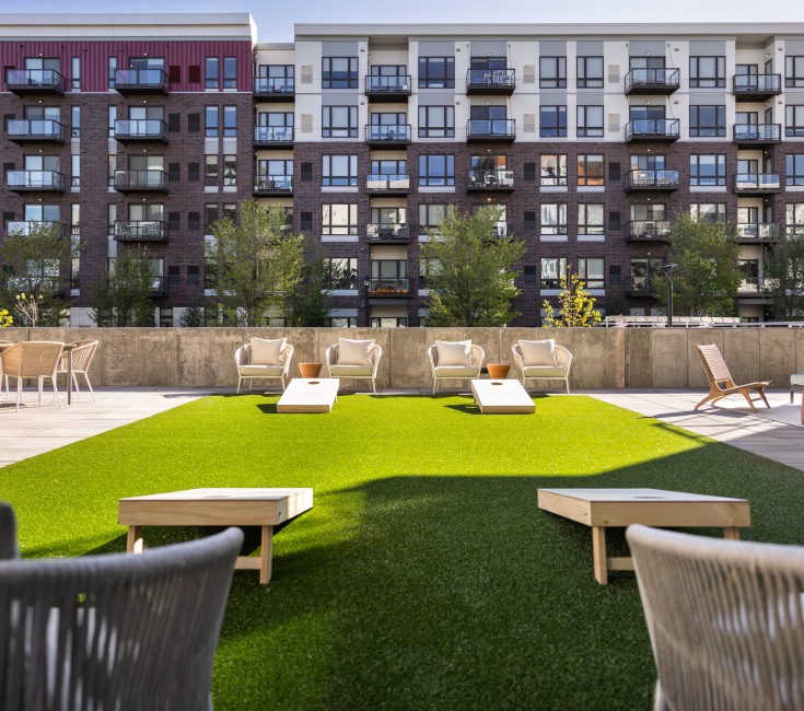 Turf area with seating and cornhole