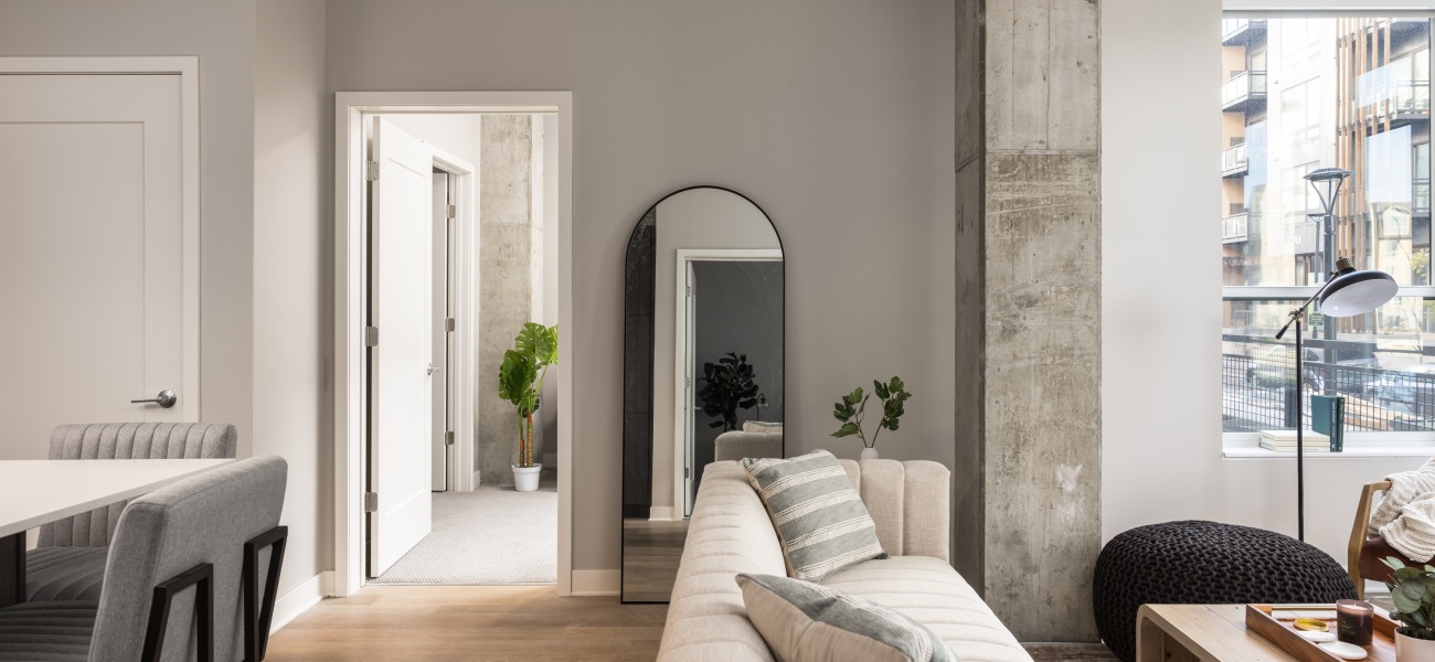 Illuminated Spaces for the Soul Living room seating with couch and mirror